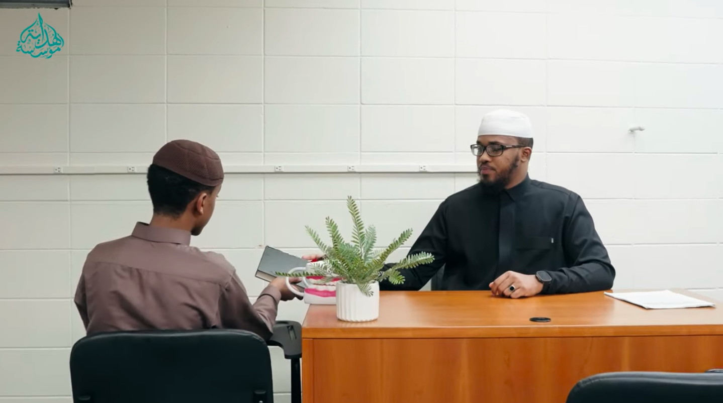 Ustadh Abdalla sitting across from and listening to a Hidayah Institute student recite